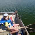 Bella with a nice fish caught on her new rod, won at the Dragon Lake Fish-in 2014
