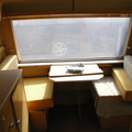 Front (hitch end) seats 2 at table, converts to single bed with single cot second bunk above.