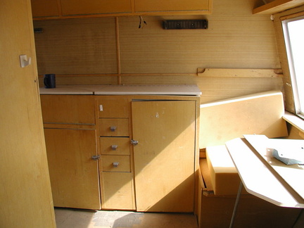 looking in the door, you can see where the poles for the upper cot go on the right above the seat.