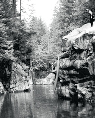 Dropping in to the Capilano River in the '80s. Adam Lewis is observing from above.