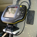 Fishfinder lying on the seat beside the closed flush mount.