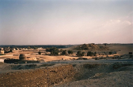 View back to Cairo from giza. Back of the spinx in the left fore ground.